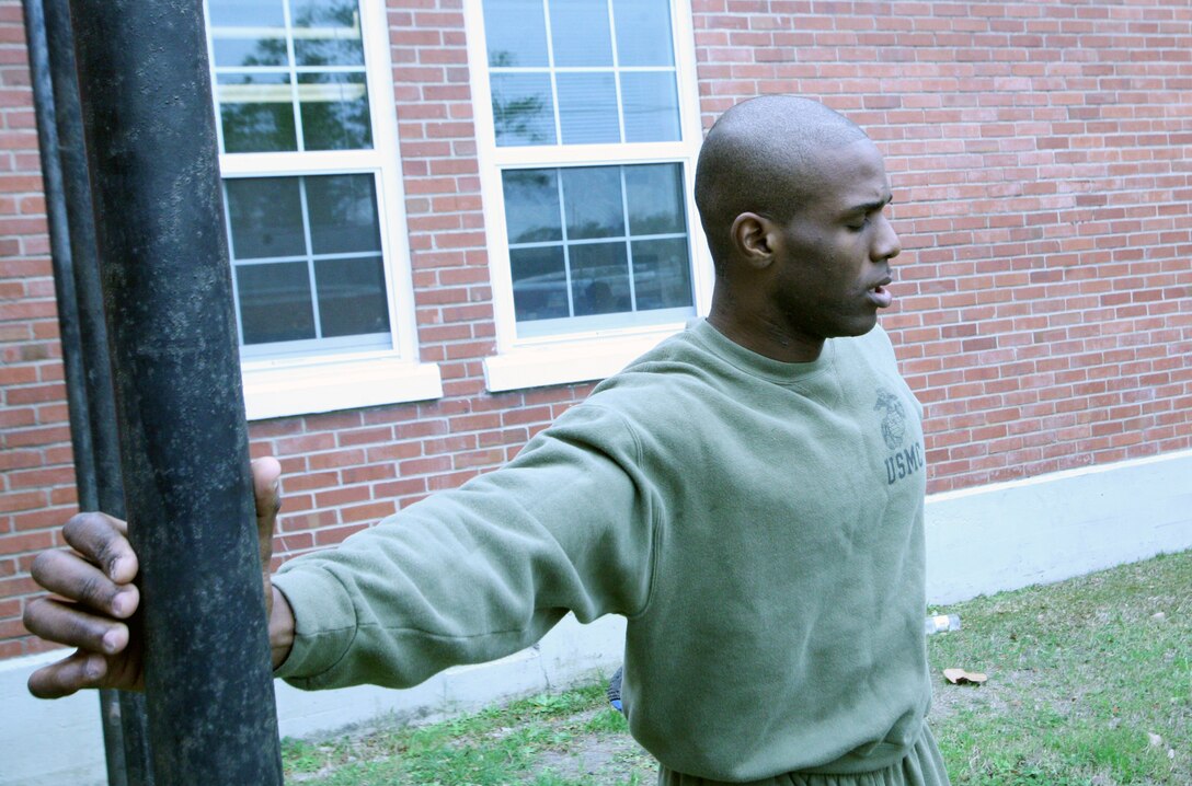 Lance Cpl. Kenny Jeanfelix, a legal service specialist with Combat Logistics Regiment 27, 2nd Marine Logistics Group, performs a stretch during physical training aboard Camp Lejeune, N.C., Feb. 27, 2012. The Brooklyn, N.Y., native was nominated for a meritorious promotion after being chosen by Staff Sgt. Tony Holmes, the military justice staff noncommissioned officer in charge, for his leadership, abilities and traits. (U.S. Marine Corps photo by Pfc. Franklin E. Mercado)