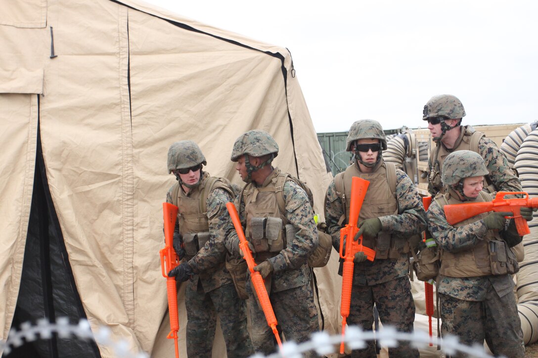 Sgt. Anthony Klein, a Marine Wing Support Squadron 171 combat engineer (back), instructs MWSS-171 combat engineers on how to properly enter a tent before clearing it during a patrolling exercise here Feb. 18. MWSS-171 Marines and sailors practice patrolling exercises in order to ensure mission effectiveness in a combat environment.