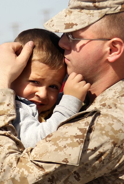 Lance Cpl. Joshua Slone, training noncommisioned officer, Headquarters and Service Co., 1st Battalion, 7th Marine Regiment, holds his son, Joseph, 3, one last time before departind with 1/7's advance party to Afghanistan Feb. 29, 2012.