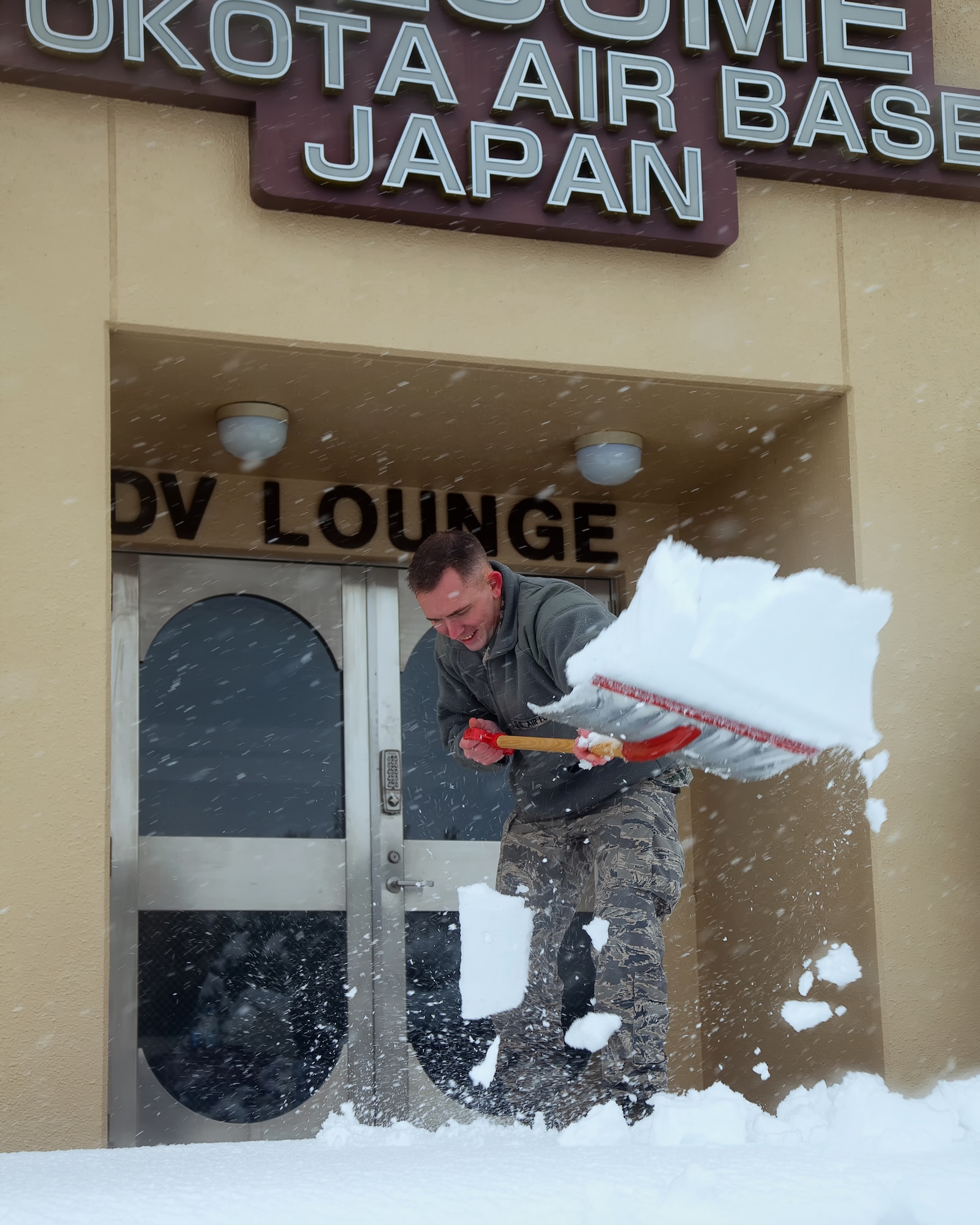 YOKOTA AIR BASE, Japan -- Capt. Jeremy Stowers, 374th Operations Support Squadron, shovels snow to clear the sidewalk in front of the distinguished visitor lounge, Feb. 29, 2012 at Yokota Air Base, Japan. Eight and a half inches of snow fell in fifteen hours, causing base leadership to call out the plows to clear the runway, taxiways and roadways. According to the 374th Operations Support Squadron weather flight, the snowfall was caused from an abundance of moisture from "Shanghai Low", the low pressure system which usually moves along the southern coastline of Japan.  (U.S. Air Force photo/Osakabe Yasuo)