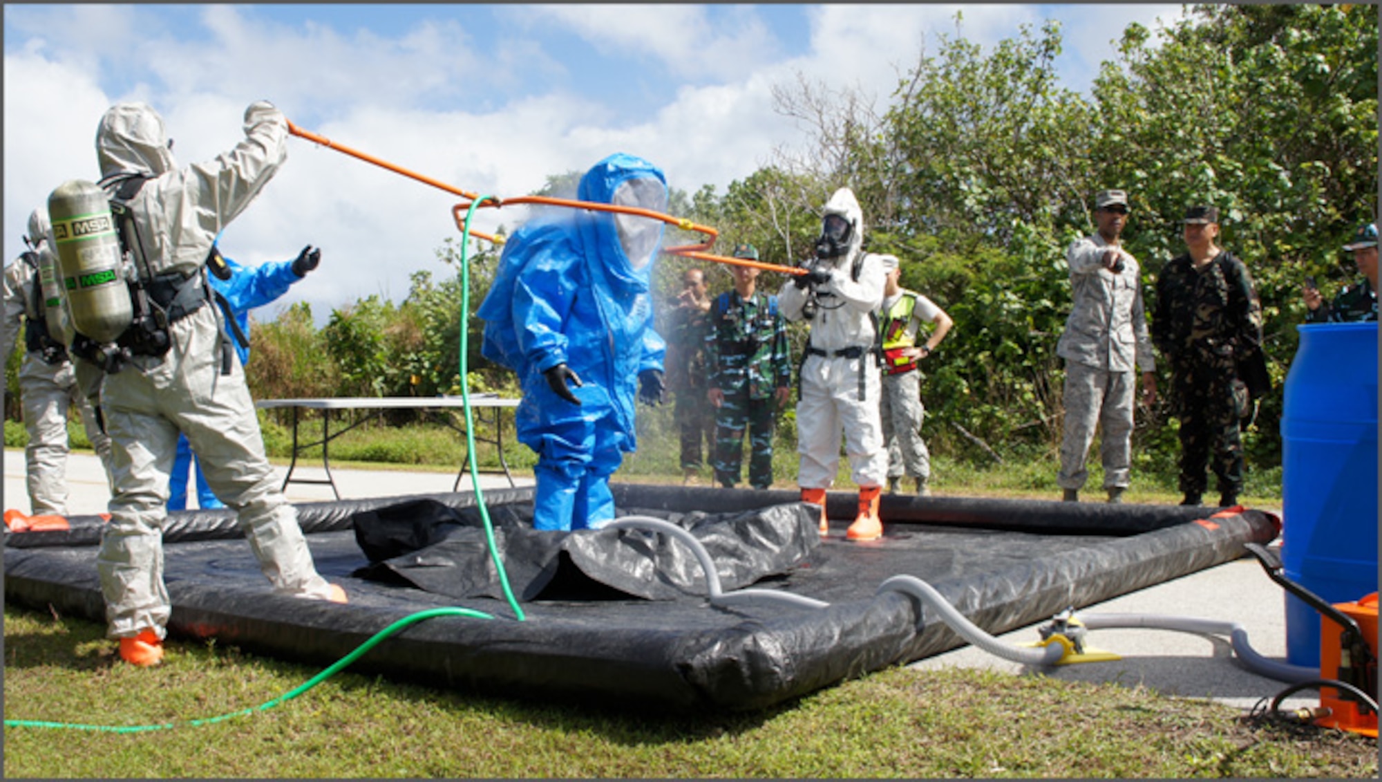 Airmen demonstrate emergency management and decontamination procedures as delegates from the Philippine Air Force, Royal Cambodian Air Force, Royal Lao Air Force, Royal Thai Air Force, Mongolian Air Force and Vietnam People’s Air Force look on. As part of U.S. Pacific Command’s Theater Security Cooperation Program, a multilateral subject-matter expert exchange co-hosted by senior civil engineer and security forces personnel from Headquarters 13th Air Force concluded here Feb. 23. (U.S. Air Force photo/ Capt. Grant Harwell)