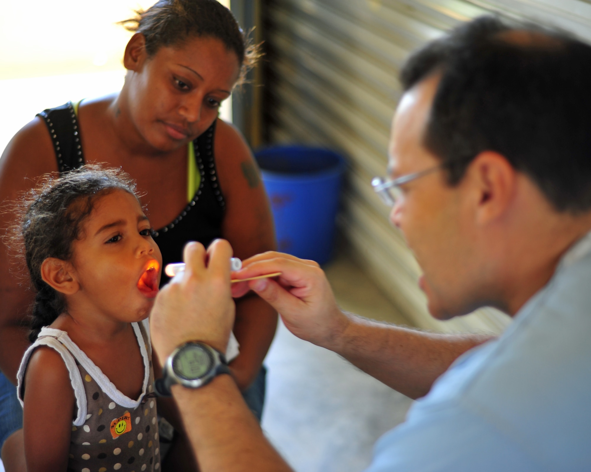 INDEPENDENCE, Belize - Dr. Ricardo Aviles, Medical Element doctor, examines a Belizean child on the final day of the two-day joint medical readiness training exercise here Feb. 29. (U.S. Air Force photo/Staff Sgt. Bryan Franks)
