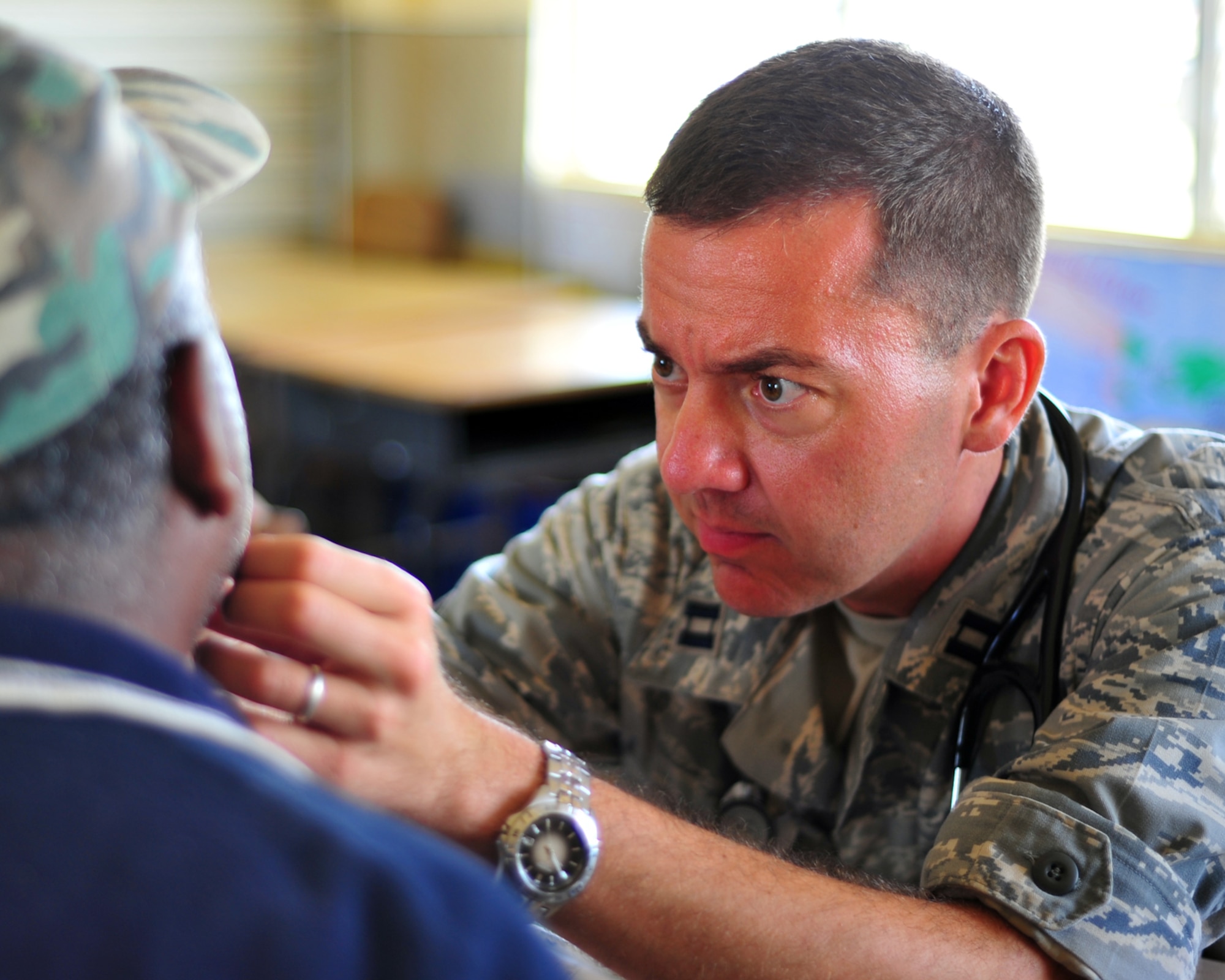 INDEPENDENCE, Belize - U.S. Air Force Capt. Eric Baroni, Medical Element physician assistant, examines a patient during the joint medical readiness training exercise here Feb. 29. The Joint MEDRETE team which consisted of members from the Belize Ministries of Health and Education, Belize Defence Force and Joint Task Force-Bravo, Soto Cano Air Base, Honduras provided medical services to include 1,120 patients screenings, 55 HIV tests, 46 women’s wellness visits and over 466 medications distributed. (U.S. Air Force photo/Staff Sgt. Bryan Franks)
