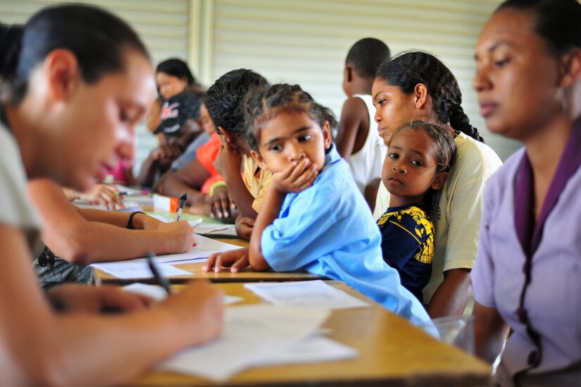 INDEPENDENCE, Belize – A little girl waits while her mother explains her medical condition to a joint medical readiness training exercise member here Feb. 29. The Joint MEDRETE team which consisted of members from the Belize Ministries of Health and Education, Belize Defence Force and Joint Task Force-Bravo, Soto Cano Air Base, Honduras provided medical services to include 1,120 patients screened, 55 HIV testings, 46 women’s wellness visits and over 466 medications distributed. (U.S. Air Force photo/Staff Sgt. Bryan Franks)
