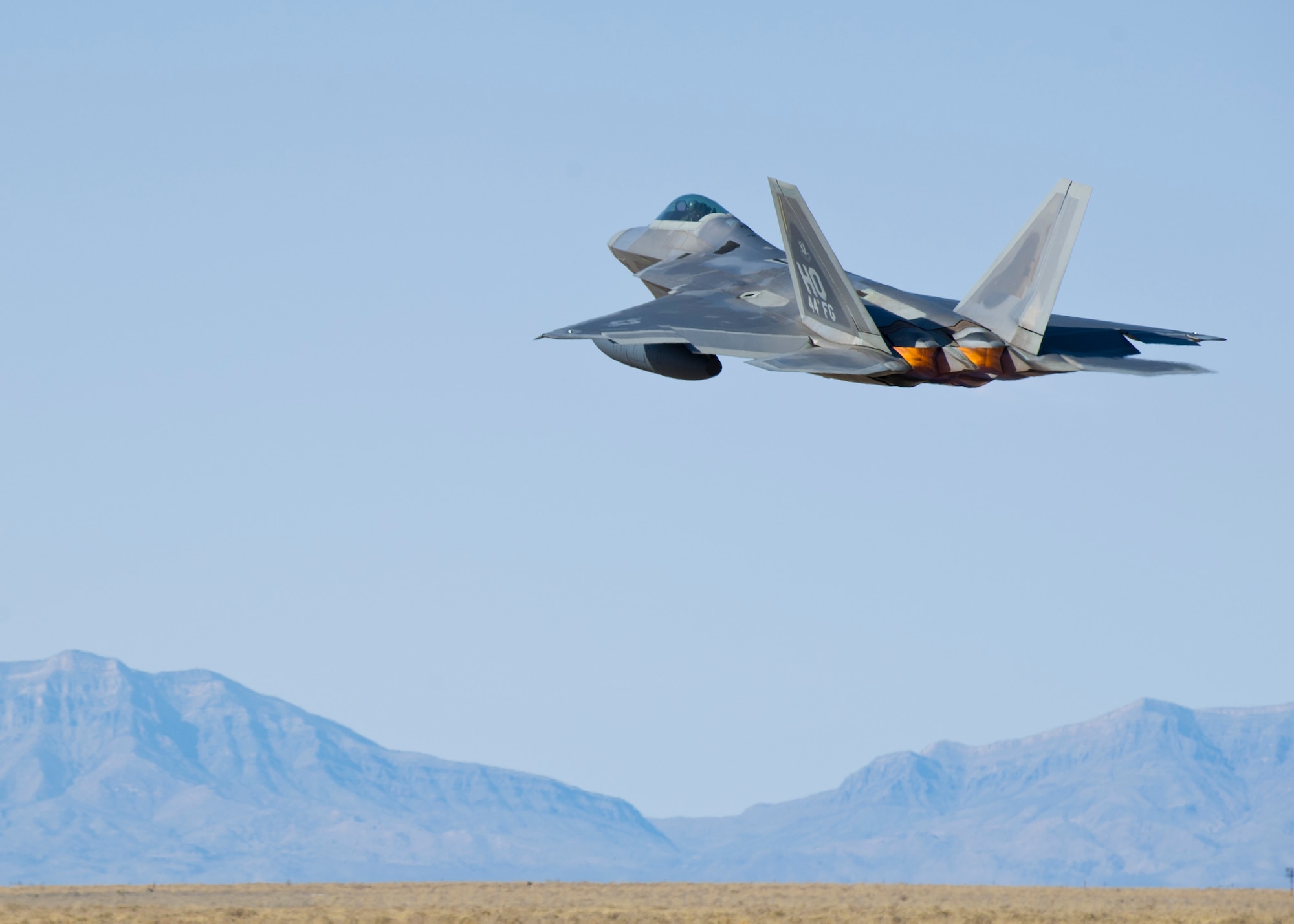 HOLLOMAN AIR FORCE BASE, N.M. – An F-22 Raptor completes its take-off from the runway here Feb. 29.  Airmen across the base work together in an effort to ensure every aircraft is combat ready. (U.S. Air Force photo by Airman 1st Class Daniel E. Liddicoet/Released) 