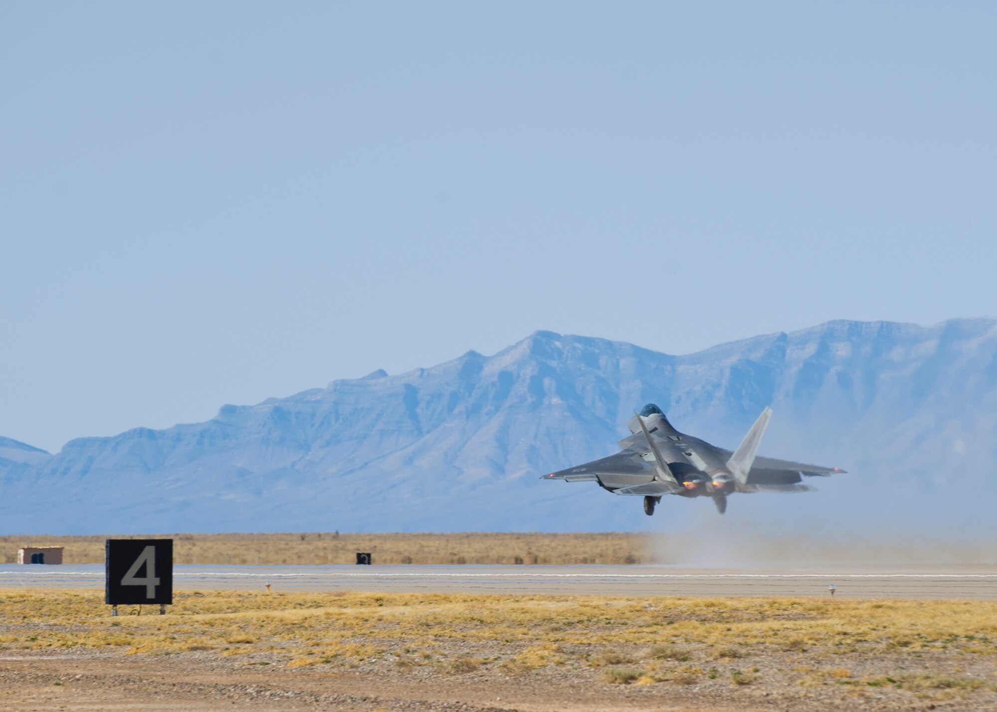 HOLLOMAN AIR FORCE BASE, N.M. – An F-22 Raptor starts to lift up during its take-off from the runway here Feb. 29.  The launching of 15 consecutive F-22 Raptors marked the culmination of a Phase 1 Operational Readiness Exercise at Holloman.  (U.S. Air Force photo by Airman 1st Class Daniel E. Liddicoet/Released) 