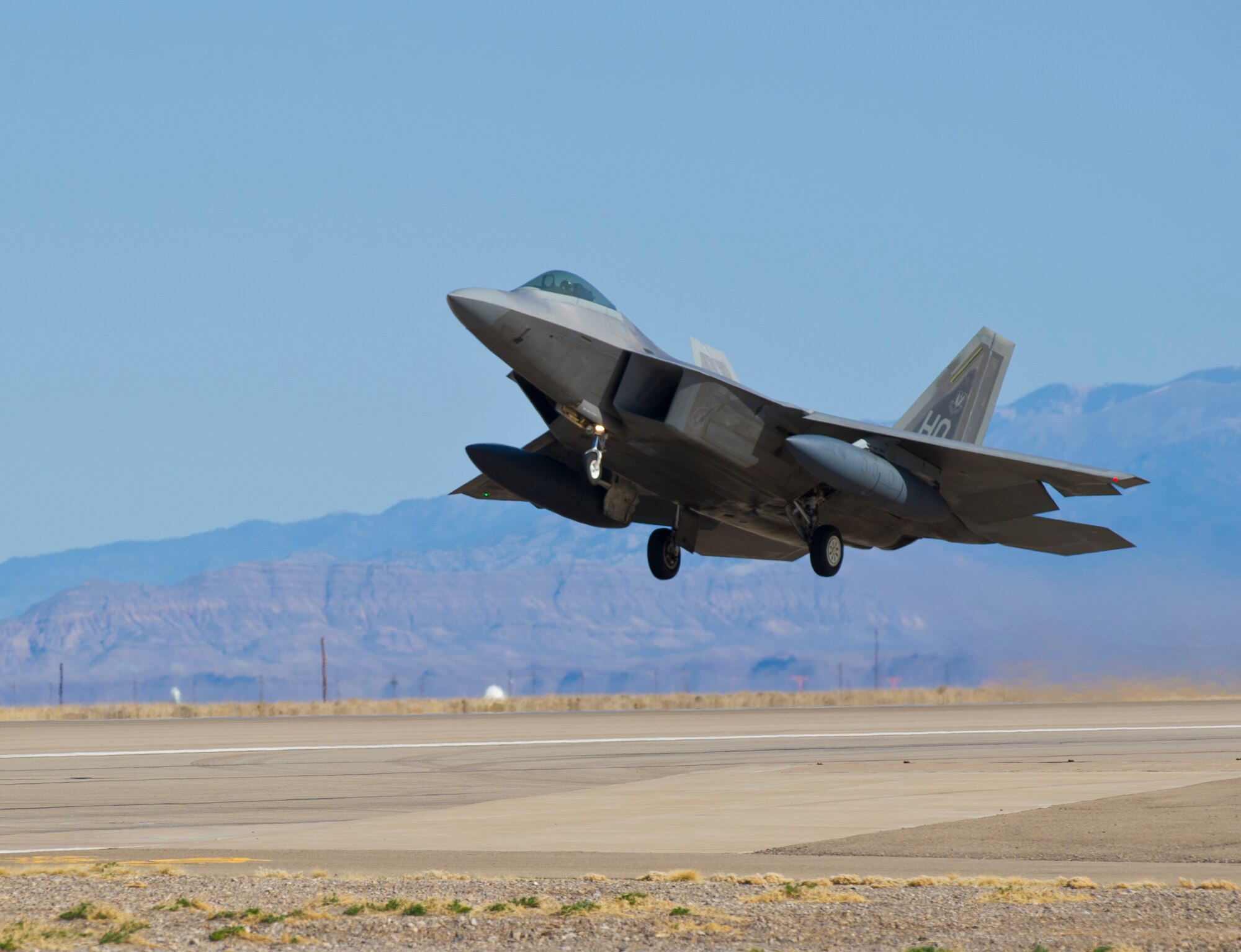 HOLLOMAN AIR FORCE BASE, N.M. – An F-22 Raptor starts to lift up during its take-off from the runway here Feb. 29.  Airmen across the base work together in an effort to ensure every aircraft is combat ready. (U.S. Air Force photo by Airman 1st Class Daniel E. Liddicoet/Released) 