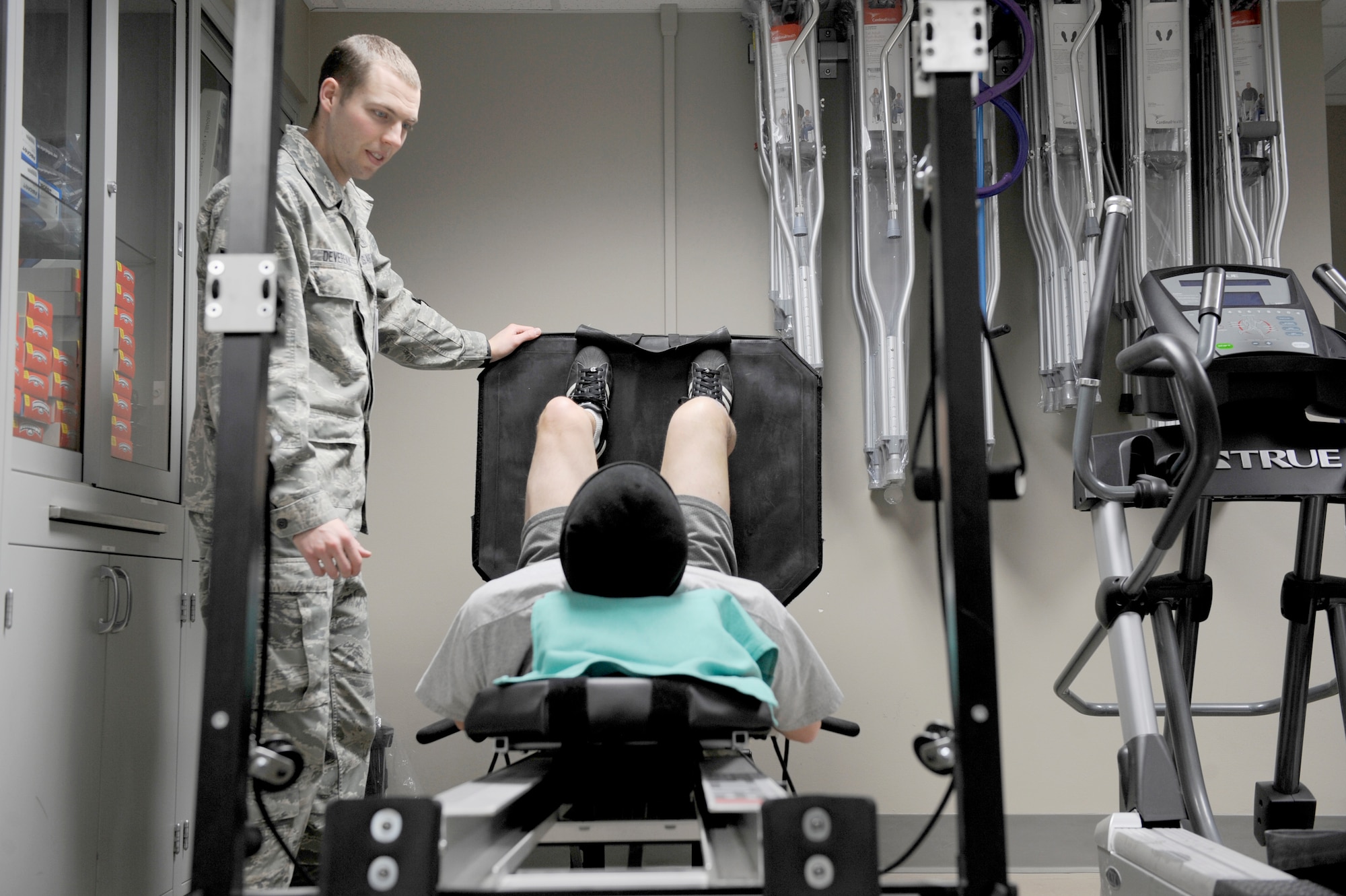 Staff Sgt. Sean Devereaux, 92nd Medical Squadron physical therapy craftsman, evaluates a patient during a follow-up appointment Feb. 10 at the physical therapy clinic. (U.S. Air Force photos by Airman 1st Class Earlandez Young)