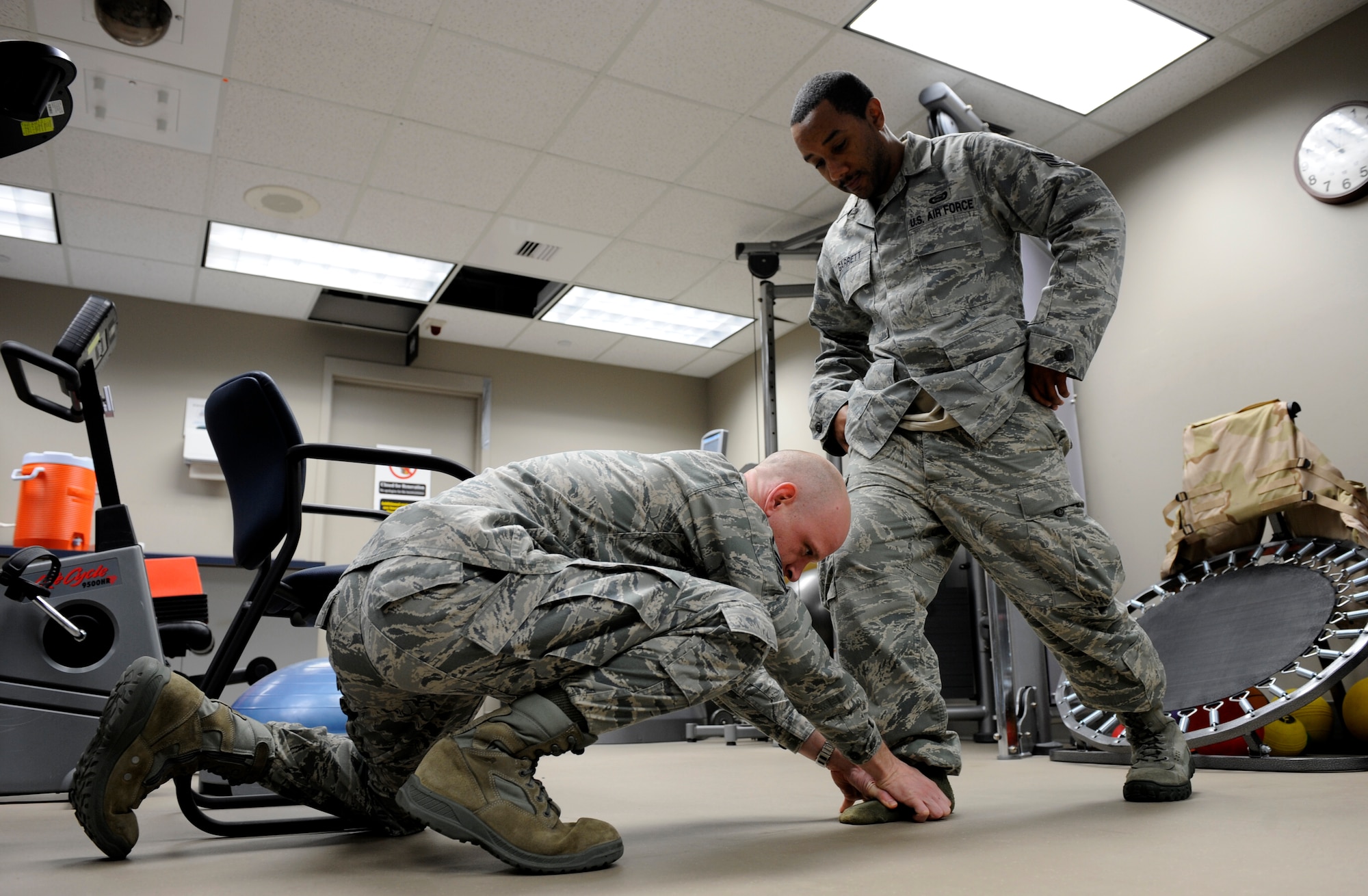 Master Sgt. Daniel Davis, 92nd Medical Squadron NCO in charge, tests out the ankle strength of Staff Sgt. Vincent Garrett, 509th Weapons Squadron, Feb. 10 at the physical therapy clinic. (U.S. Air Force photo by Airman 1st Class Earlandez Young)