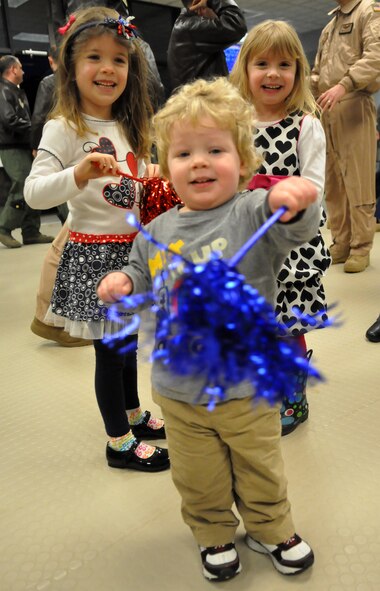 Children entertain each other following the return of Airmen from the 7th Airlift Squadron Feb. 29, 2012, at Joint Base Lewis-McChord, Wash. More than 120 Airmen from the 7th AS were greeted by family and friends after a 60-day deployment in support of Operations Enduring Freedom, New Dawn, Odyssey Dawn and Combined Joint Task Force-Horn of Africa. (U.S. Air Force photo/Airman 1st Class Leah Young)
