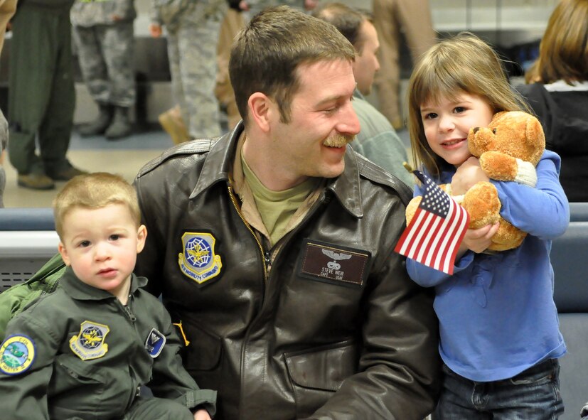 Capt. Stephen Weir, 7th Airlift Squadron pilot, spends time with his children after returning from a deployment Feb. 29, 2012, at Joint Base Lewis-McChord, Wash. More than 120 Airmen returned from a 60-day deployment in support of Operations Enduring Freedom, New Dawn, Odyssey Dawn and Combined Joint Task Force-Horn of Africa. (U.S. Air Force photo/Adamarie Lewis-Page)