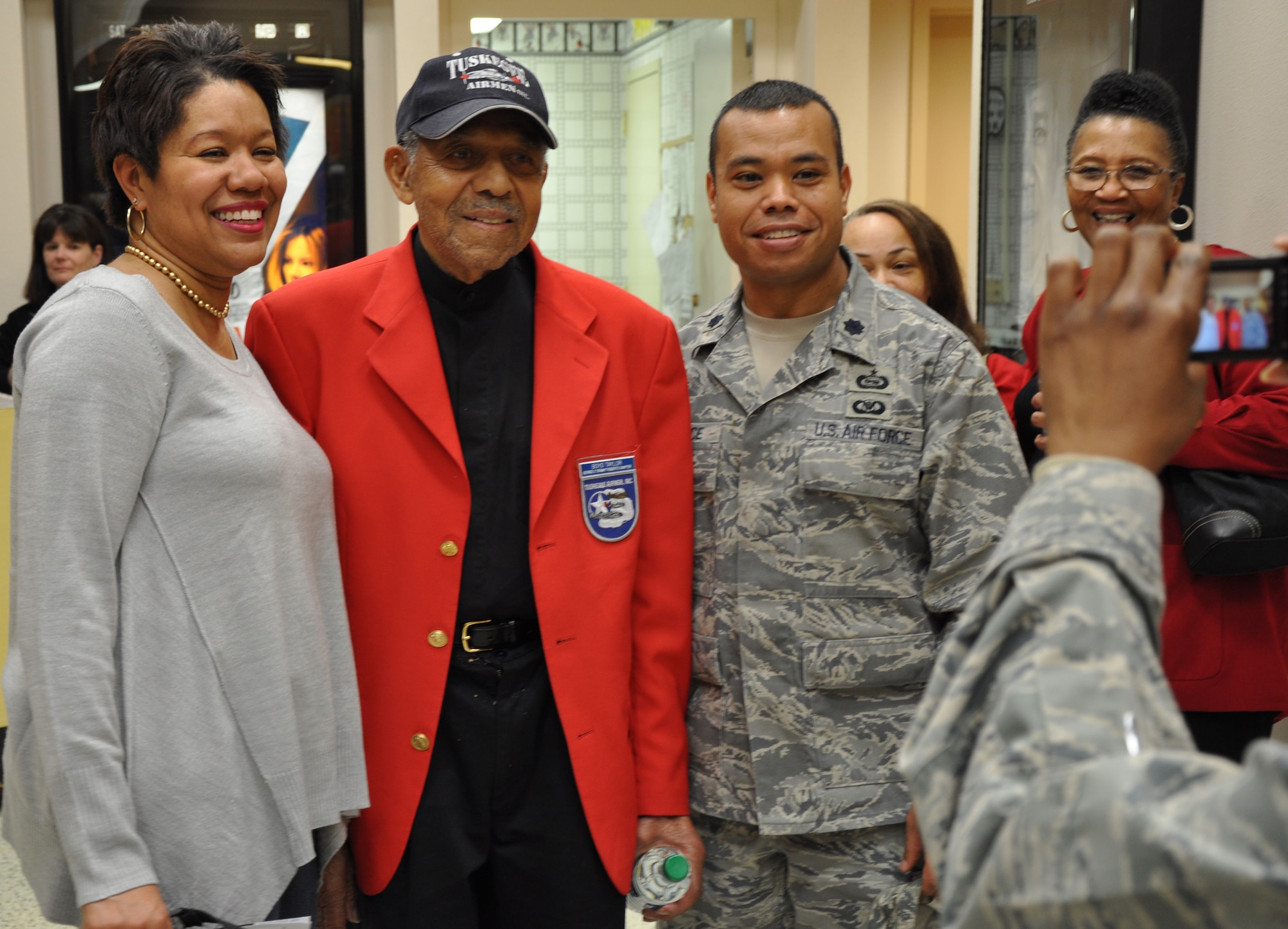 Tuskegee Airmen Tech. Sgt. (Ret.) Boyd Taylor (center) poses for a photo with Lt. Col. James Lawrence and his wife Khim, at the base theater at Beale Air Force Base Calif., Feb. 24, 2012. Tuskegee Airmen from a local TA inc. chapter showed a screening of the movie “Red Tails” in honor of the base’s celebration of African-American/Black History Month. (U.S. Air Force photo by Staff Sgt. Robert M. Trujillo/Released)