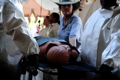 Retired Air Force Brig. Gen. Theresa Casey instructs members from the 628th Medical Group on properly decontaminating a patient before a timed trial during the In Place Patient Decontamination training at Joint Base Charleston, S.C., Feb. 23, 2012. The training is designed to to prepare Airmen to provide care during a chemical, biological, radiological or nuclear catastrophe. Casey is an instructor with Decon LLC. (U.S. Air Force photo/Staff Sgt. Nicole Mickle)