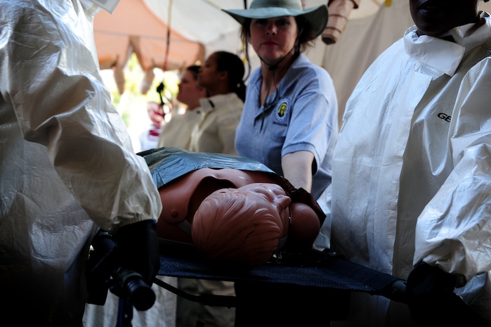 Retired Air Force Brig. Gen. Theresa Casey instructs members from the 628th Medical Group on properly decontaminating a patient before a timed trial to complete the In Place Patient Decontamination training at the clinic, Joint Base Charleston - Air Base, Feb. 23.  The training is designed to to prepare Airmen to provide care during a chemical, biological, radiological or nuclear catastrophe.   Casey is an instructor with Decon LLC.  (U.S. Air Force photo/ Staff Sgt. Nicole Mickle)  
