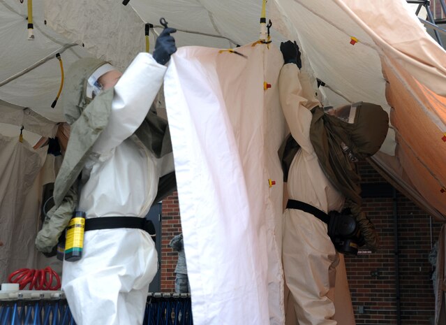 Airmen participate in the In Place Patient Decontamination training at Joint Base Charleston - Air Base Feb. 23. The training is designed to prepare Airmen to provide care during a chemical, biological, radiological or nuclear catastrophe. The team was required to be fully operational in 20 minutes in order to pass the training. The 628th Medical Group team was able to accomplish the task in 12 minutes. (U.S. Air Force photo/Airman 1st Class Ashlee Galloway)