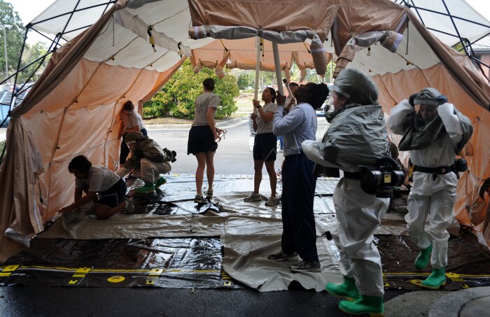 Airmen from the 628th Medical Group put up a tent during a timed trial to complete the In Place Patient Decontamination training at Joint Base Charleston - Air Base Feb. 23. The training is designed to prepare Airmen to provide care during a chemical, biological, radiological or nuclear catastrophe. The team was required to be fully operational in 20 minutes in order to pass the training. The 628th MDG team was able to accomplish the task 12 minutes. (U.S. Air Force photo/Airman 1st Class Ashlee Galloway)