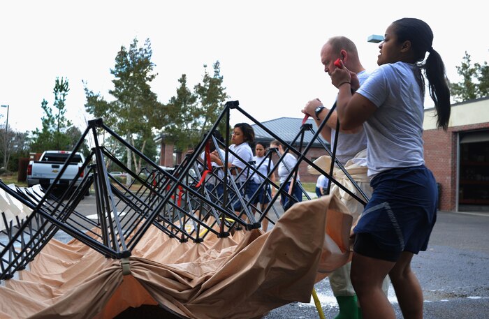 Tech. Sgt. Anthony Waldon assists Airman 1st Class Matthew Douglas with his paperwork during an inventory at the 628th Security Forces Squadron warehouse at Joint Base Charleston - Air Base Feb. 27. The warehouse coordinates daily, weekly and yearly accountability supply reports ensuring error free transaction processing for inventory totaling more than $3.2 million. Waldon is a 628th SFS supply non-commissioned officer in charge and Douglas is a 628th SFS journeyman. (U.S. Air Force photo/Staff Sgt. Katie Gieratz) 