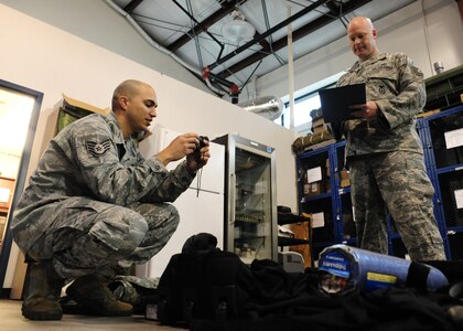 Staff Sgt. Vincent Bustillo and Tech.Sgt. Anthony Waldo take inventory of mobility gear at the 628th Security Forces Squadron warehouse at Joint Base Charleston - Air Base Feb. 27. 628th SFS forces are responsible for issuing individual field equipment required for contingency operations and ensuring security forces and unit task code standards are maintained. Bustillo is a 628th SFS vehicle non-commissioned officer in charge and Waldon is a 628th SFS supply NCOIC. (U.S. Air Force photo/Staff Sgt. Katie Gieratz) 

