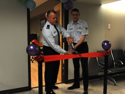 Col. Erik Hansen and Airman Trevor Vascellaro cut the ribbon at the recently renovated Passenger Terminal family lounge at Joint Base Charleston - Air Base Feb. 27. Hansen is the 437th Airlift Wing commander and Vascellaro is assigned to the 437th Aerial Port Squadron, 437th AW. (U.S. Air Force photo/Airman 1st Class Ashlee Galloway)