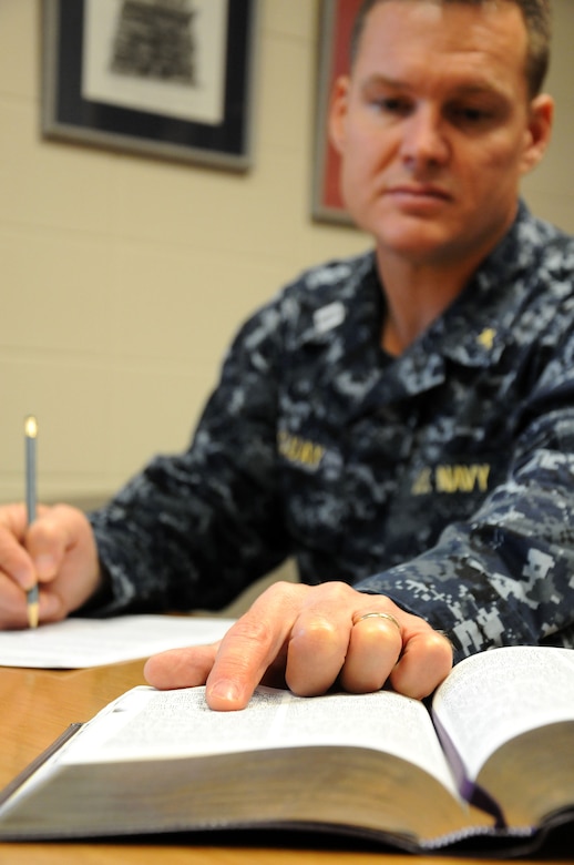 Navy Chaplain Lt. John Quay, refers to his Bible while preparing a Sunday sermon. Quay is a 628th Air Base Wing chaplain assigned to All Saint’s Chapel at Joint Base Charleston - Weapons Station. (U.S. Navy photo/Petty Officer 1st Class Jennifer Hudson)