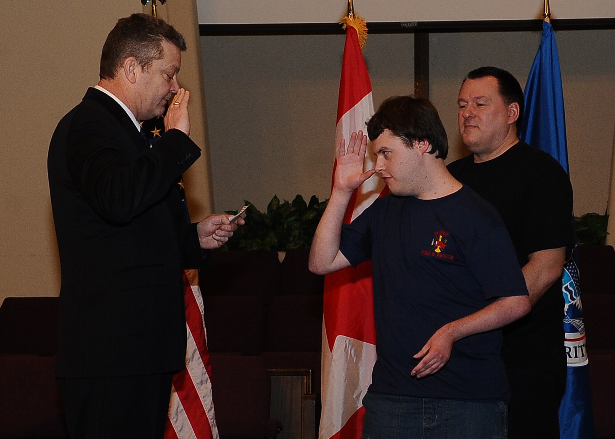 MINOT N.D. -- Marcus Anthony Cox was sworn in as an honorary special agent for his dedication and contributions to the law enforcement community at the First Assembly of God in Minot, Feb. 22. He was presented with a plaque, commemorating the event, by Mr. Peter Edge, Deputy Associate Director of Homeland Security Investigations. Ever since Cox was a young boy, he has always had the love and desire to be a part of the law enforcement community. Although faced with numerous medical challenges which he has overcome, he continues to volunteer his time to support Minot’s emergency services. Marcus’ plans for the future include staying connected to the emergency services and finding a way to actively be a part of helping to take care of people and to help keep them safe. (U.S. Air Force photo/Airman 1st Class Kristoffer Kaubisch)