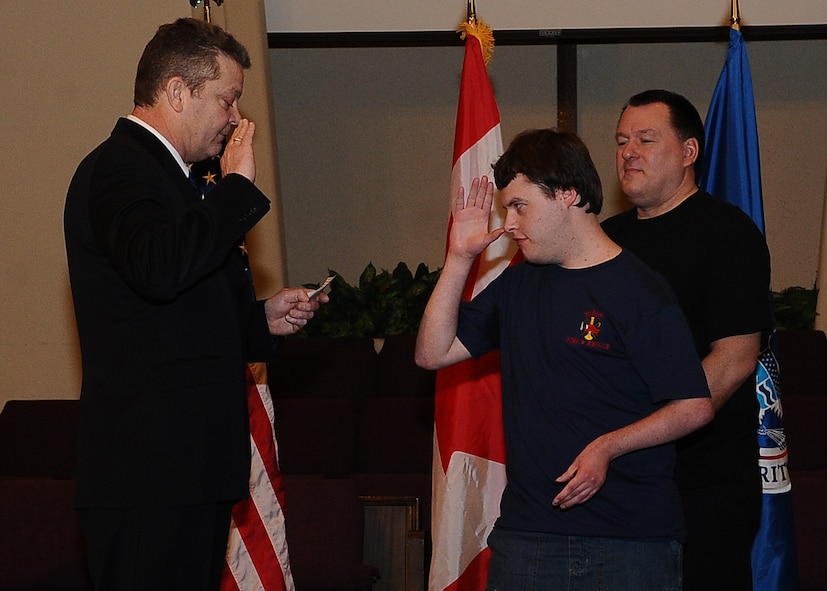 MINOT N.D. -- Marcus Anthony Cox was sworn in as an honorary special agent for his dedication and contributions to the law enforcement community at the First Assembly of God in Minot, Feb. 22. He was presented with a plaque, commemorating the event, by Mr. Peter Edge, Deputy Associate Director of Homeland Security Investigations. Ever since Cox was a young boy, he has always had the love and desire to be a part of the law enforcement community. Although faced with numerous medical challenges which he has overcome, he continues to volunteer his time to support Minot’s emergency services. Marcus’ plans for the future include staying connected to the emergency services and finding a way to actively be a part of helping to take care of people and to help keep them safe. (U.S. Air Force photo/Airman 1st Class Kristoffer Kaubisch)