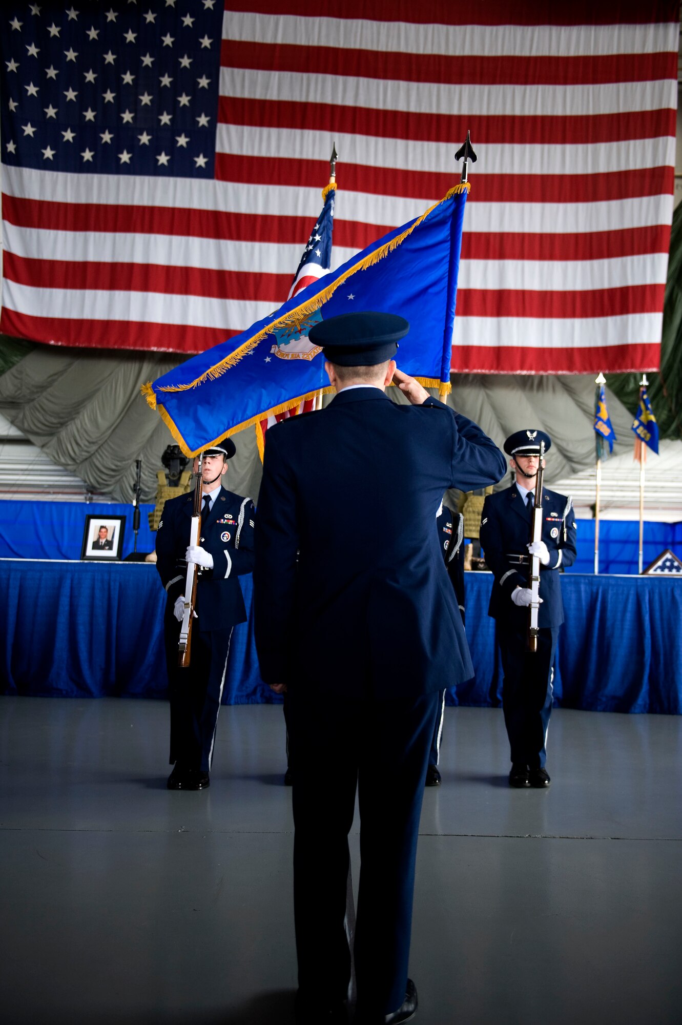 U.S. Air Force Col. Jim Slife, commander of the 1st Special Operations Wing, salutes the colors during the national anthem at a memorial ceremony inside the Freedom Hangar at Hurlburt Field, Fla., Feb. 28, 2012.  Four Airmen were involved in a U-28A accident in Africa Feb. 18, 2012. (U.S. Air Force photo/Airman 1st Class Gustavo Castillo)(Released)