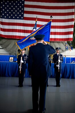 U.S. Air Force Col. Jim Slife, commander of the 1st Special Operations Wing, salutes the colors during the national anthem at a memorial ceremony inside the Freedom Hangar at Hurlburt Field, Fla., Feb. 28, 2012.  Four Airmen were involved in a U-28A accident in Africa Feb. 18, 2012. (U.S. Air Force photo/Airman 1st Class Gustavo Castillo)(Released)