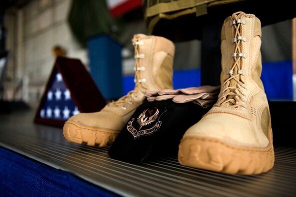 A display of tactical gear rests on a stage during a memorial ceremony inside the Freedom Hangar at Hurlburt Field, Fla., Feb. 28, 2012.  The ceremony was held to honor the service and contributions the four fallen Airmen made to their country. (U.S. Air Force photo/Airman 1st Class Gustavo Castillo)(Released)