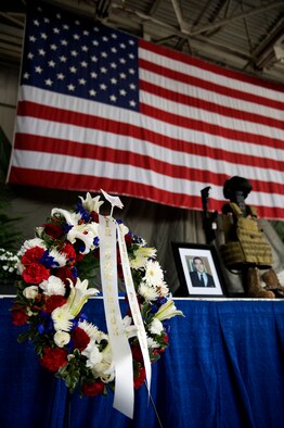 A wreath of flowers stands near a memorial display in the Freedom Hangar at Hurlburt Field, Fla., Feb. 28, 2012.  The wreath and articles of clothing are presented as a memorial to the service and sacrifice of the fallen Airmen in the Feb. 18, 2012, U-28A crash. (U.S. Air Force photo/Airman 1st Class Gustavo Castillo)(Released)