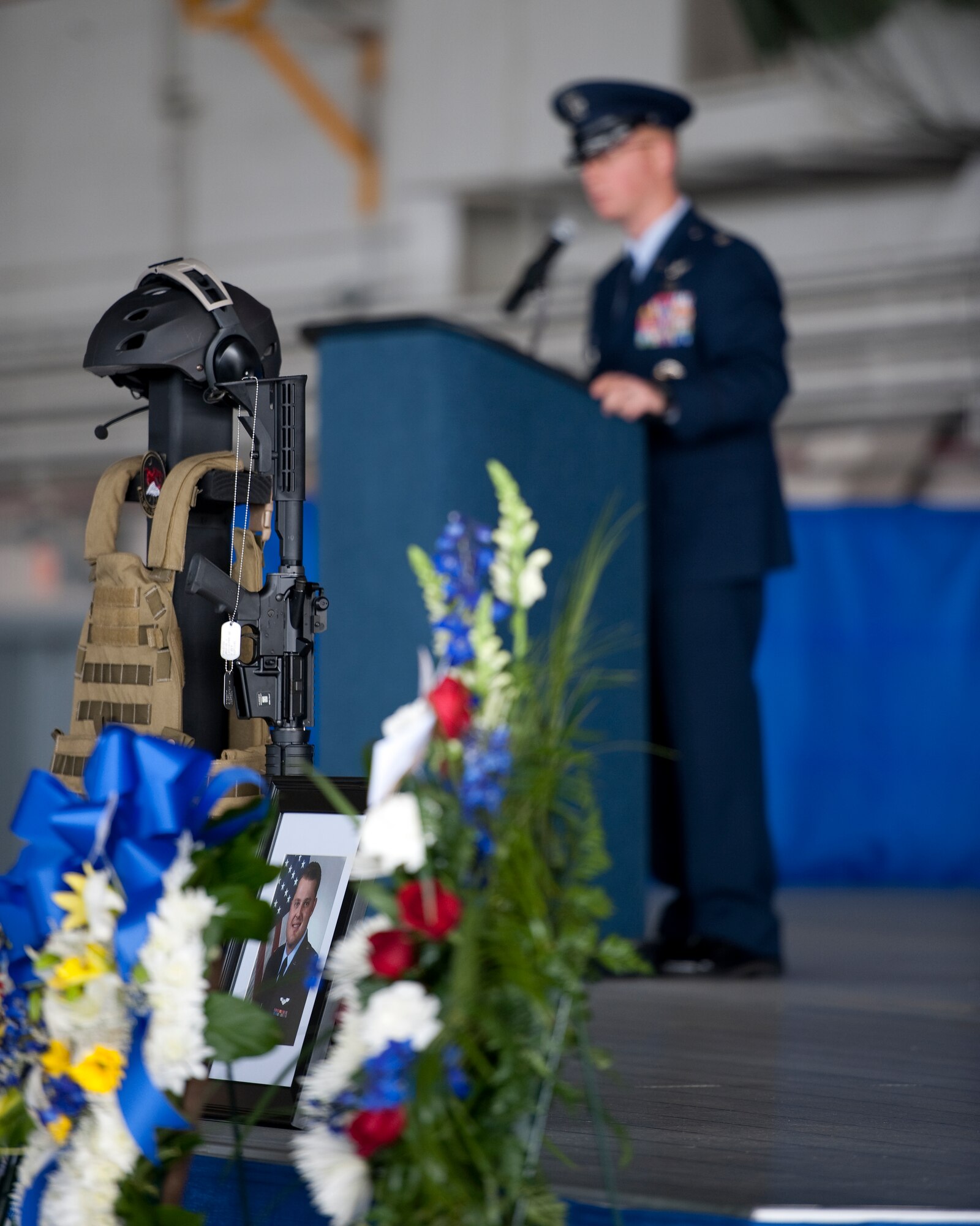 A memorial wreath and photo honoring 1st Lt. Justin T. Wilkens, a combat systems officer from the 34th Special Operations Squadron, is on display during a memorial service at Freedom Hangar on Hurlburt Field, Fla., Feb. 28, 2012. Wilkens and three fellow Airmen passed away Feb. 18, 2012, when their U-28A was involved in an accident over Africa. (U.S. Air Force photo/Airman 1st Class Christopher Williams)(Released)