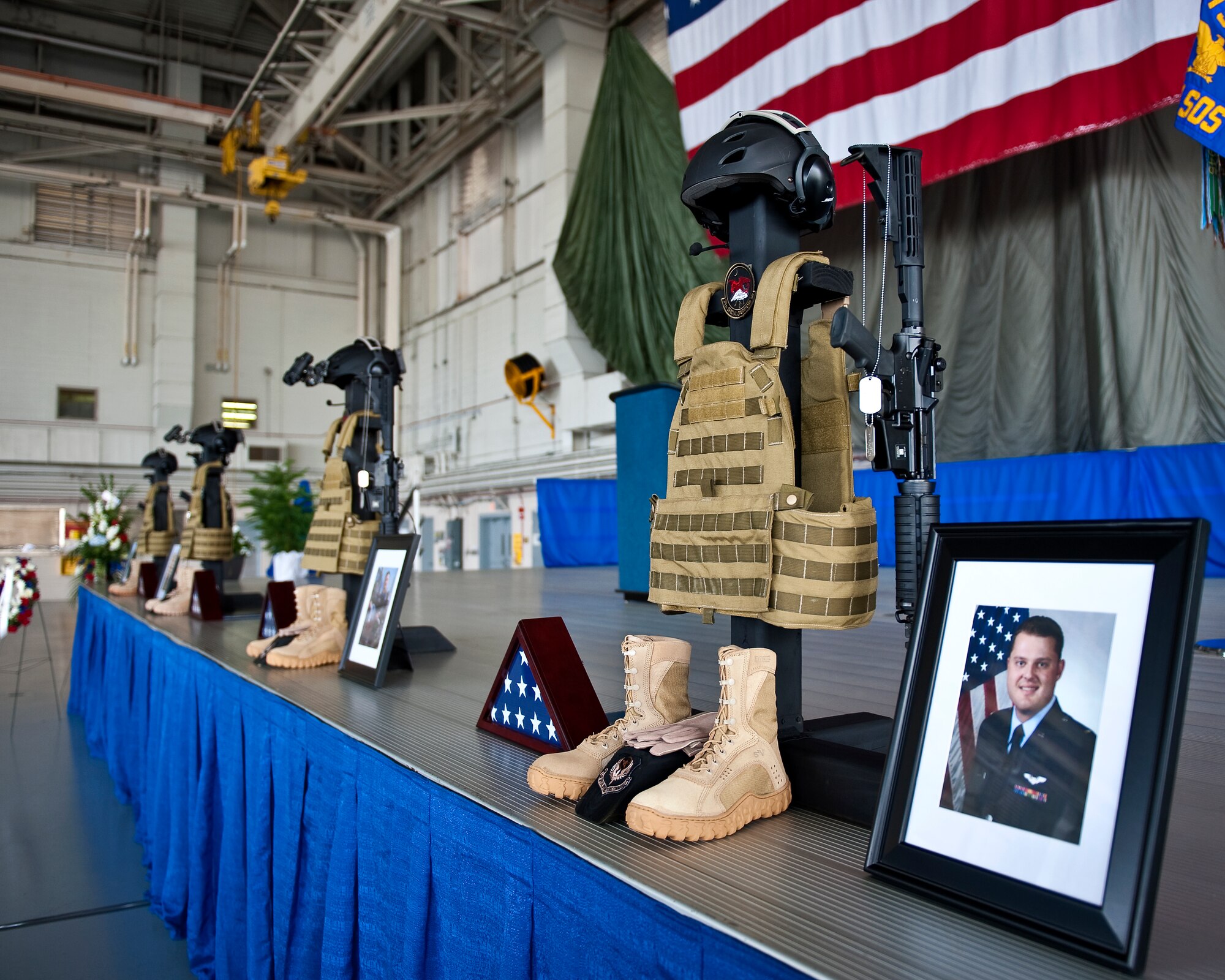 A memorial wreath and photo honoring 1st Lt. Justin T. Wilkens, a combat systems officer from the 34th Special Operations Squadron, is on display during a memorial service at Freedom Hangar on Hurlburt Field, Fla., Feb. 28, 2012. Wilkens and three fellow Airmen passed away Feb. 18, 2012, when their U-28A was involved in an accident over Africa. (U.S. Air Force photo/Airman 1st Class Christopher Williams)(Released)