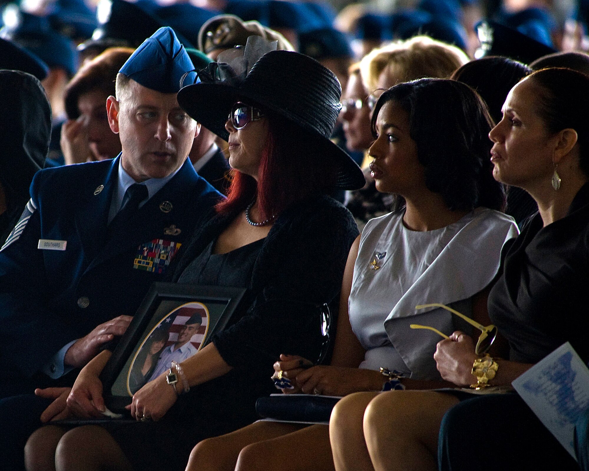 Yumiko Southard, Senior Airman Julian S. Scholten's mother, is comforted by step-father Sr. Master Sgt. Leon Southard II while Scholten's wife, Diamond and mother-in-law Dorothy Clark look on during a ceremony held at Hurlburt Field, Fla., Feb. 28, 2012, honoring Scholten and three other Hurlburt Airmen killed in a Feb. 18, 2012, U-28A crash in Djibouti, Africa. (U.S. Air Force photo/Staff Sgt. Vanessa Valentine)(Released)