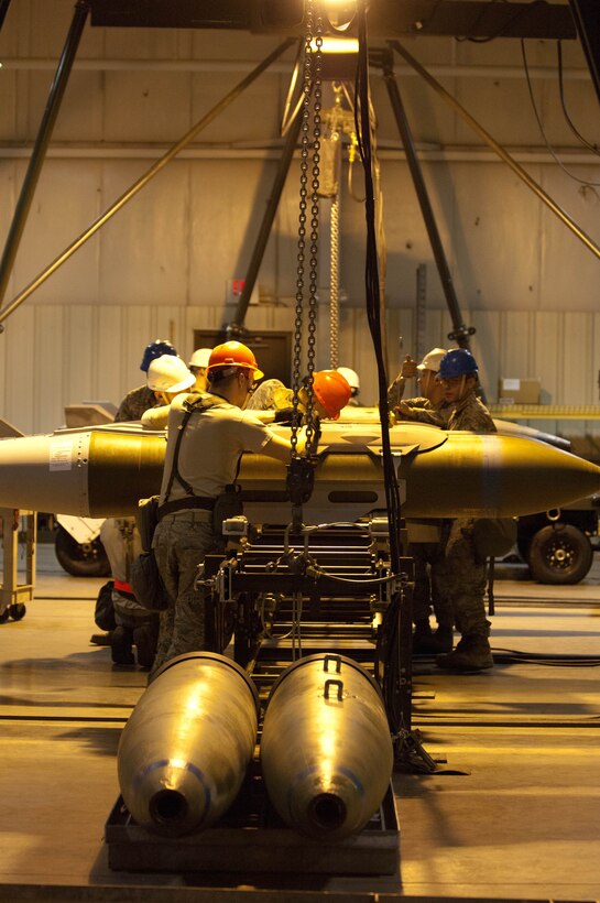Conventional maintenance crew members assigned to the 28th Munitions Squadron assemble and load inert GBU-31V munitions during an Operational Readiness Exercise at Ellsworth Air Force Base, S.D., Feb. 22, 2012. The 28th MUNS Airmen are responsible for 1,707 munitions line items, 86 facilities and a 647-acre munitions storage area to support B-1 bomber operations. (U.S. Air Force photo by Airman 1st Class Zachary Hada/Released)