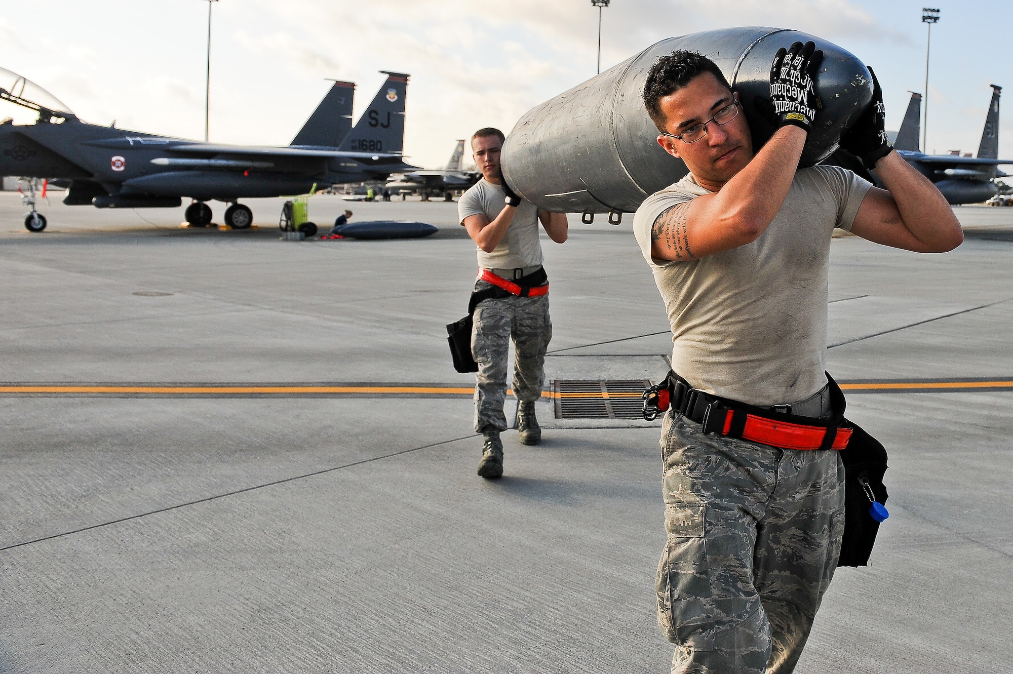 U.S. Air Force Airmen 1st Class Steven Clingerman and Kyle Jackson transport a travel pod during exercise Global Guardian 2012 at the National Guard Combat Readiness Training Center in Savannah, Ga., Feb. 22, 2012.  This exercise provides participants, which include Army, Air Force and coalition forces, an opportunity to perfect their skills in a realistic joint and multinational environment, simulating scenarios seen in modern combat. Clingerman and Jackson are 333rd Aircraft Maintenance Unit weapons load crew members. (U.S. Air Force photo/Master Sgt. Roger Parsons/Released)