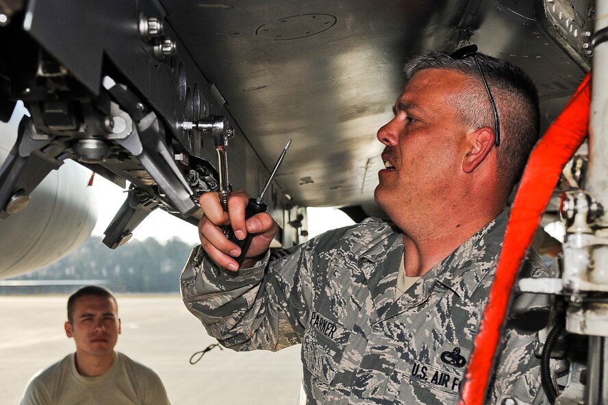U.S. Air Force Master Sgt. George Parker fixes a BRU-47 bomb rack as Airman 1st Class Kyle Jackson observes during exercise Global Guardian 2012 at the National Guard Combat Readiness Training Center in Savannah, Ga., Feb. 22, 2012. The bomb rack allows Airmen to load munitions permit faster and easier as well as reduce maintenance and cleaning. Parker, 333rd Aircraft Maintenance Unit section chief, is from St. Thomas, U.S. Virgin Islands. Jackson is a 333rd Aircraft Maintenance Unit weapons load crew member. (U.S. Air Force photo/Master Sgt. Roger Parsons/Released)
