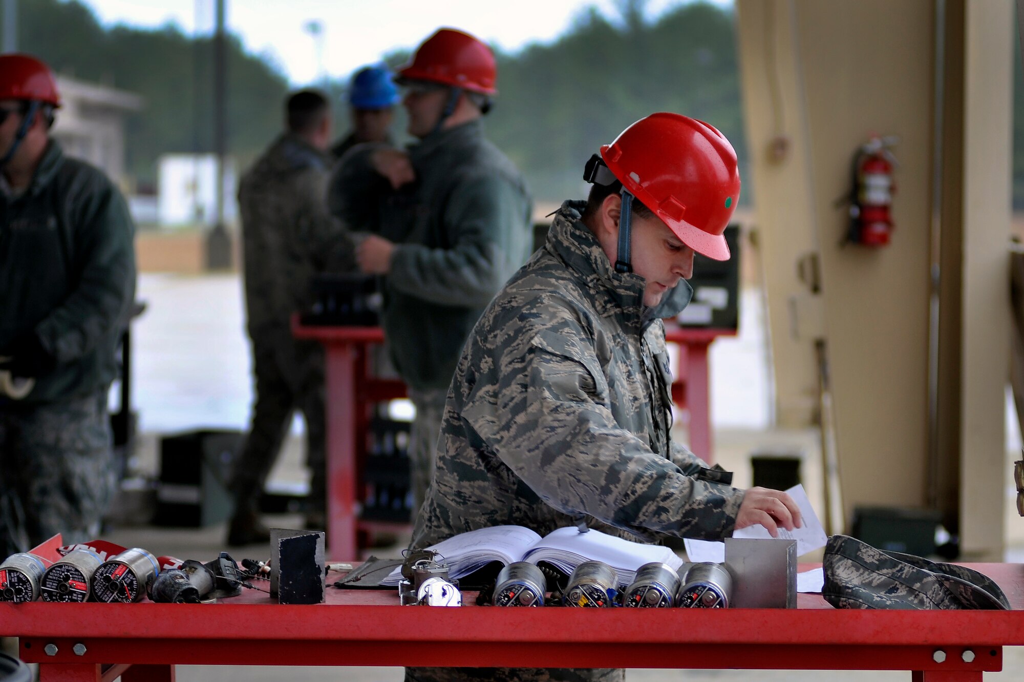 U.S. Air Force Tech. Sgt. David Coughtry, 20th Equipment Maintenance Squadron munitions flight, organized technical order manuals to aid his crew while building several inert guided bomb units, Feb. 27, 2012, Shaw Air Force Base, S.C. The weapons were assembled in preparation for an upcoming Operational Readiness Exercise. (U.S. Air Force photo by Senior Airman Kenny Holston/Released)

