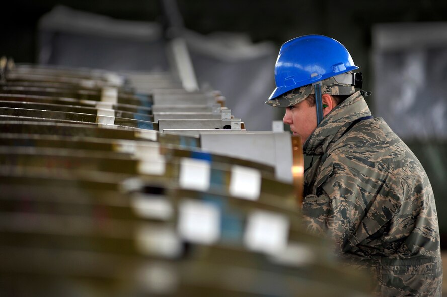 U.S. Air Force Senior Airman Chris Marlow, 20th Equipment Maintenance Squadron munitions flight, ensures everything is properly aligned while helping assemble inert guided bomb units, Feb. 27, 2012, Shaw Air Force Base, S.C. The weapons were assembled in preparation for an upcoming Operational Readiness Exercise. (U.S. Air Force photo by Senior Airman Kenny Holston/Released)
