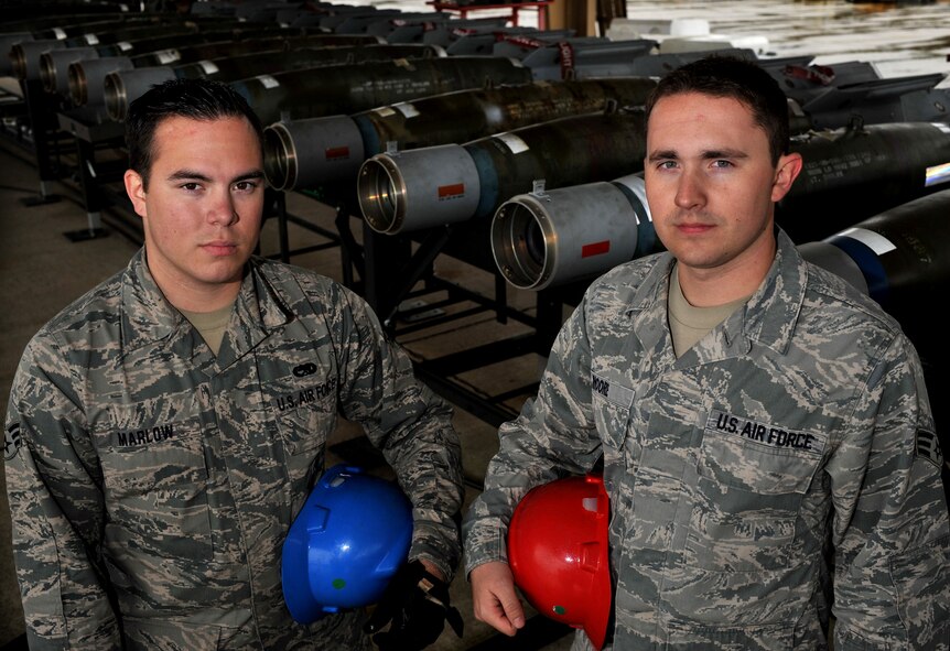 U.S. Air Force Senior Airman Chris Marlow and Senior Airman Jason Moore, both 20th Equipment Maintenance Squadron munitions flight, were a part of a 12-man crew who built 46 inert guided bomb units, Feb. 27, 2012, Shaw Air Force Base, S.C. The weapons were assembled in preparation for an upcoming Operational Readiness Exercise. (U.S. Air Force photo by Senior Airman Kenny Holston/Released)