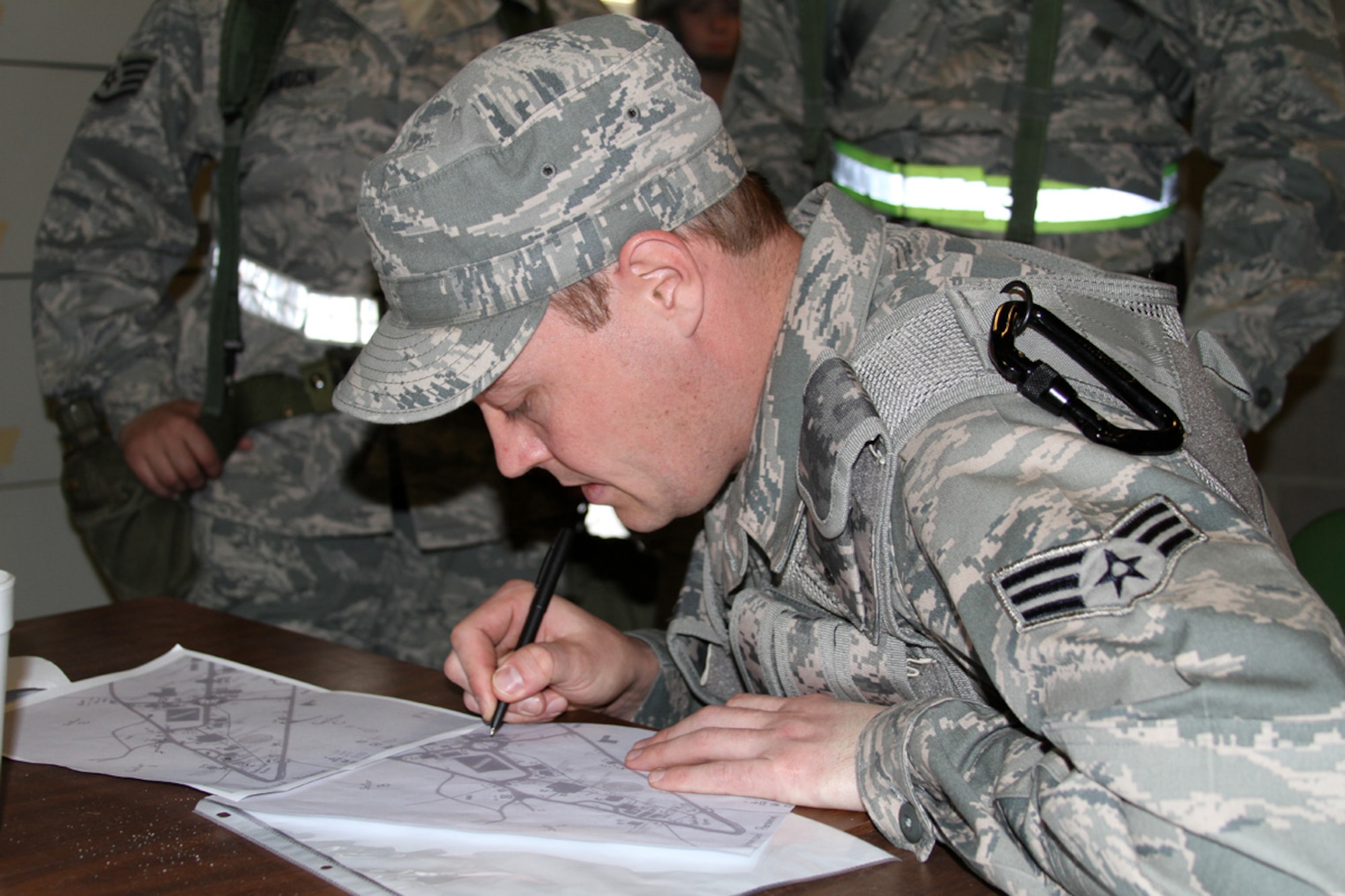 Senior Airman Ryan Dunlap plots out points on a map at the Georgia National Guard Combat Readiness Training Center, Feb. 19, 2012. Dunlap, a member of the 127th Civil Engineer Squadron at Selfridge Air National Guard Base, Mich., was participating in the Global Guardian training exercise, Feb. 13-24. During the exercise, more than 1,300 Soldiers and Airmen of the National Guard, as well as members of the Royal Netherland Air Force and Canadian Air Force, trained to respond to a terrorist attack or natural disaster in the U.S. Approximately a half dozen Airmen from Selfridge participated in the exercise, which included military personnel from more than 20 states. In addition to allowing the participating personnel to work on their individual skills, the exercise provided an opportunity for team building across the various units of the National Guard. (U.S. Air Force photo by TSgt Jaclyn Carver)