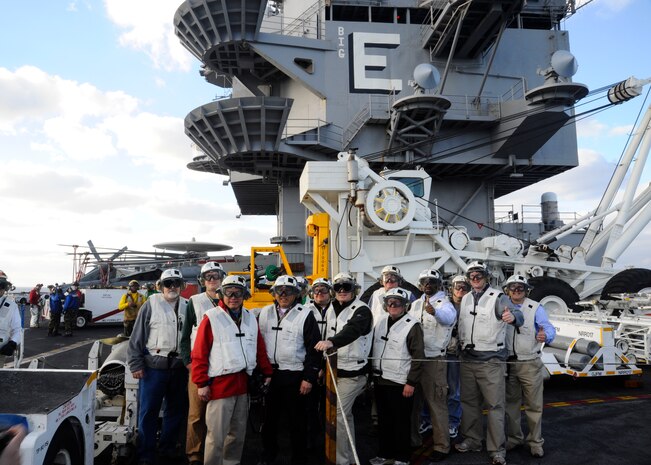 Twelve community leaders from around the country pose for a group photo Jan 16, 2012, during a Distinguished Visitors Embark on board the USS Enterprise (CVN 65). The ship was 75 miles of the coast of Florida and was conducting pre-deployment exercises. The Navy’s DV embark program is designed to increase awareness of the Navy's mission by selecting community leaders to share their experiences with the largest possible audience. (Courtesy photo) 