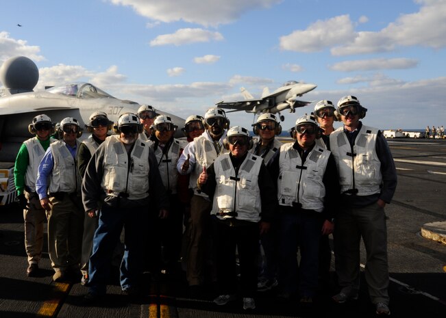 Twelve community leaders from around the country pose for a group photo Jan 16, 2012, during a Distinguished Visitors Embark on board the USS Enterprise (CVN 65). The ship was 75 miles of the coast of Florida and was conducting pre-deployment exercises. The Navy’s DV embark program is designed to increase awareness of the Navy's mission by selecting community leaders to share their experiences with the largest possible audience. (Courtesy photo) 