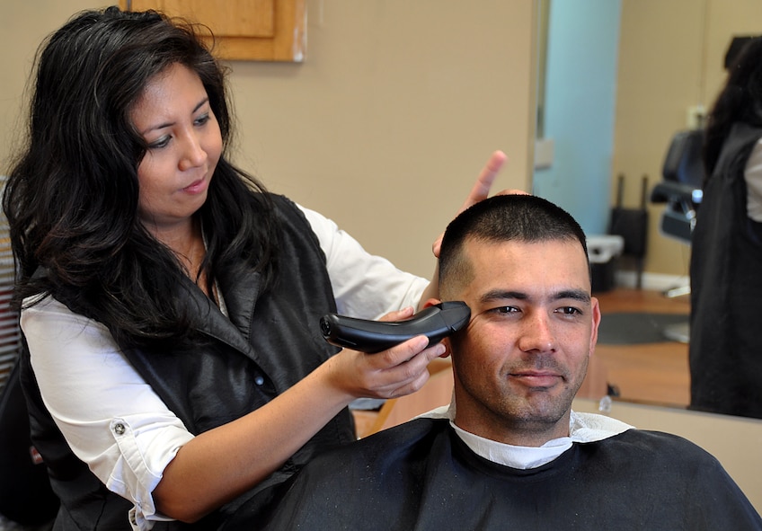 Ms. Elda Careaga, , 482nd Fighter Wing Services Contractor, cuts Mr. Jack Yuen, 482nd Fighter Wing Department of Defense police officer, hair Feb. 29. Yuen gets his hair cut regularly at the base barber shop. (U.S Air Force Photo/ Senior Airman Jacob Jimenez, 482nd Fighter Wing Public Affairs) 