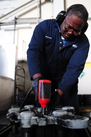 Norman Riley removes pistons from a brake at Joint Base Charleston - Air Base Feb. 23. The pistons are removed so the brakes can be overhauled for better performance. Riley is a 437th Maintenance Squadron aircraft hydraulics technician, 437th Airlift Wing. (U.S. Air Force photo/Staff Sgt. Katie Gieratz)
