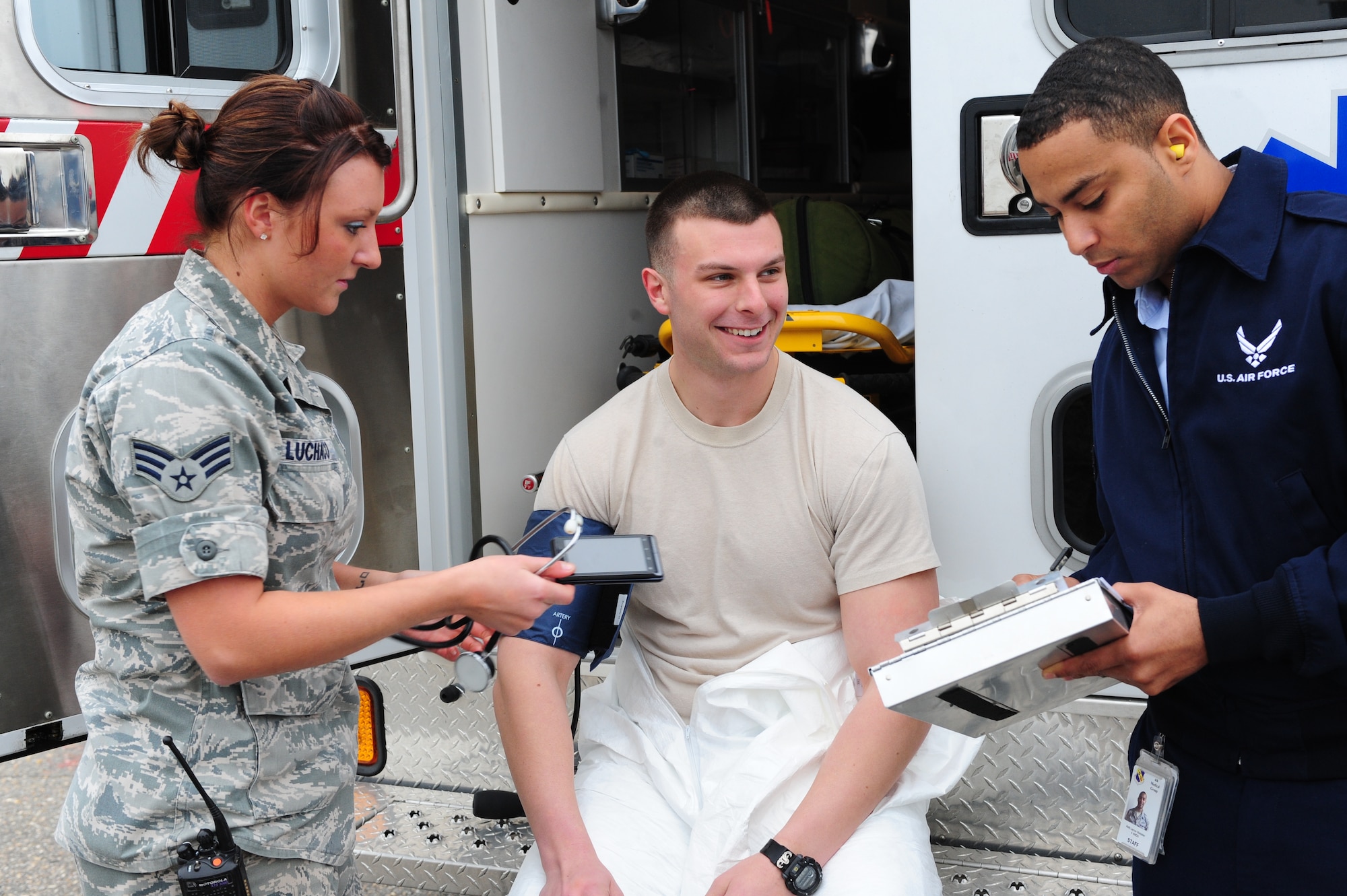 U.S. Air Force Senior Airmen Alyse Luchaco and Jarron Webster check Staff Sgt. Adam Usher’s vital signs during a nuclear major accident response exercise on Seymour Johnson Air Force Base, N.C., Feb. 27, 2012. It is a requirement for all individuals who come in close proximity to nuclear weapons to have their vitals checked before working with and after an incident to ensure no significant medical changes occurred. Luchaco, 4th Aerospace Medicine Squadron technician, hails from Homer, Alaska; Webster, 4th AMDS technician, is a native of Owensboro, Ky., and Usher, 4th Civil Engineer Squadron explosive ordnance disposal technician, hails from Philadelphia.  (U.S. Air Force photo/Airman 1st Class Mariah Tolbert/Released)