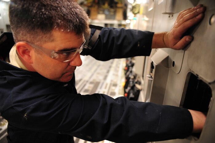 Staff Sgt. Justin Diggins checks the gust dampener on a C-17 Globemaster III prior to routine maintenance at the  Home Station Check hangar at Joint Base Charleston - Air Base  Feb. 21. The pressure has to be monitored to ensure the safety of Airmen working on the aircraft. Diggins is a 437th Maintenance Squadron aircraft hydraulics journeyman, 437th Airlift Wing. (U.S. Air Force photo/Staff Sgt. Katie Gieratz)
