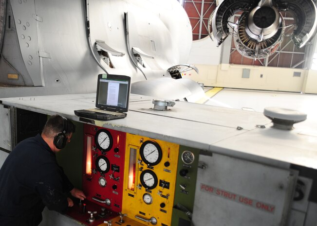 Staff Sgt. Justin Diggins checks the gauge pressure during a strut flush on a C-17 Globemaster III at the Home Station Check hangar at Joint Base Charleston - Air Base Feb. 21. The pressure is monitored to ensure the safety of Airmen working on the aircraft. Diggins is a 437th Maintenance Squadron aircraft hydraulics journeyman, 437th Airlift Wing.(U.S. Air Force photo/Staff Sgt. Katie Gieratz)