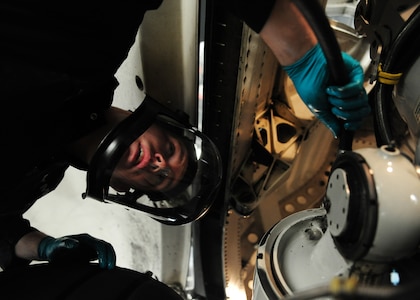 Senior Airman Robert Gresham hooks up hoses to the main landing gear strut on a C-17 Globemaster III at the Home Station Check hangar at Joint Base Charleston - Air Base  Feb. 21. The struts are flushed and filled with clean hydraulic fluid to provide better suspension for the aircraft. Gresham is a  437th Maintenance Squadron aircraft hydraulics journeyman, 437th Airlift Wing. (U.S. Air Force photo/Staff Sgt. Katie Gieratz)