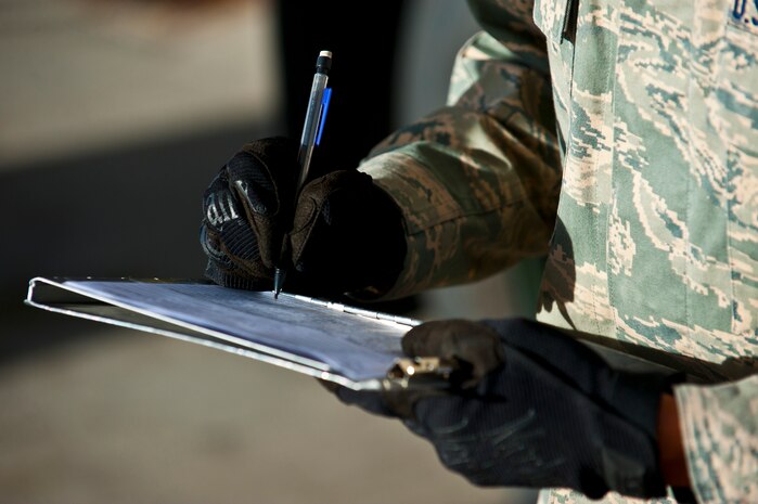 Airman 1st Class Michael Camarillo, fuels distribution apprentice, 99th Logistics Readiness Squadron, fills out a technical order Feb. 23rd, 2012 at Nellis Air Force Base, Nev. The Fuels Management Flight, responsible for fueling all aircraft at Nellis AFB, accomplishes its mission daily regardless of condition or number of airframes serviced. (U.S. Air Force photo by Senior Airman Brett Clashman)
