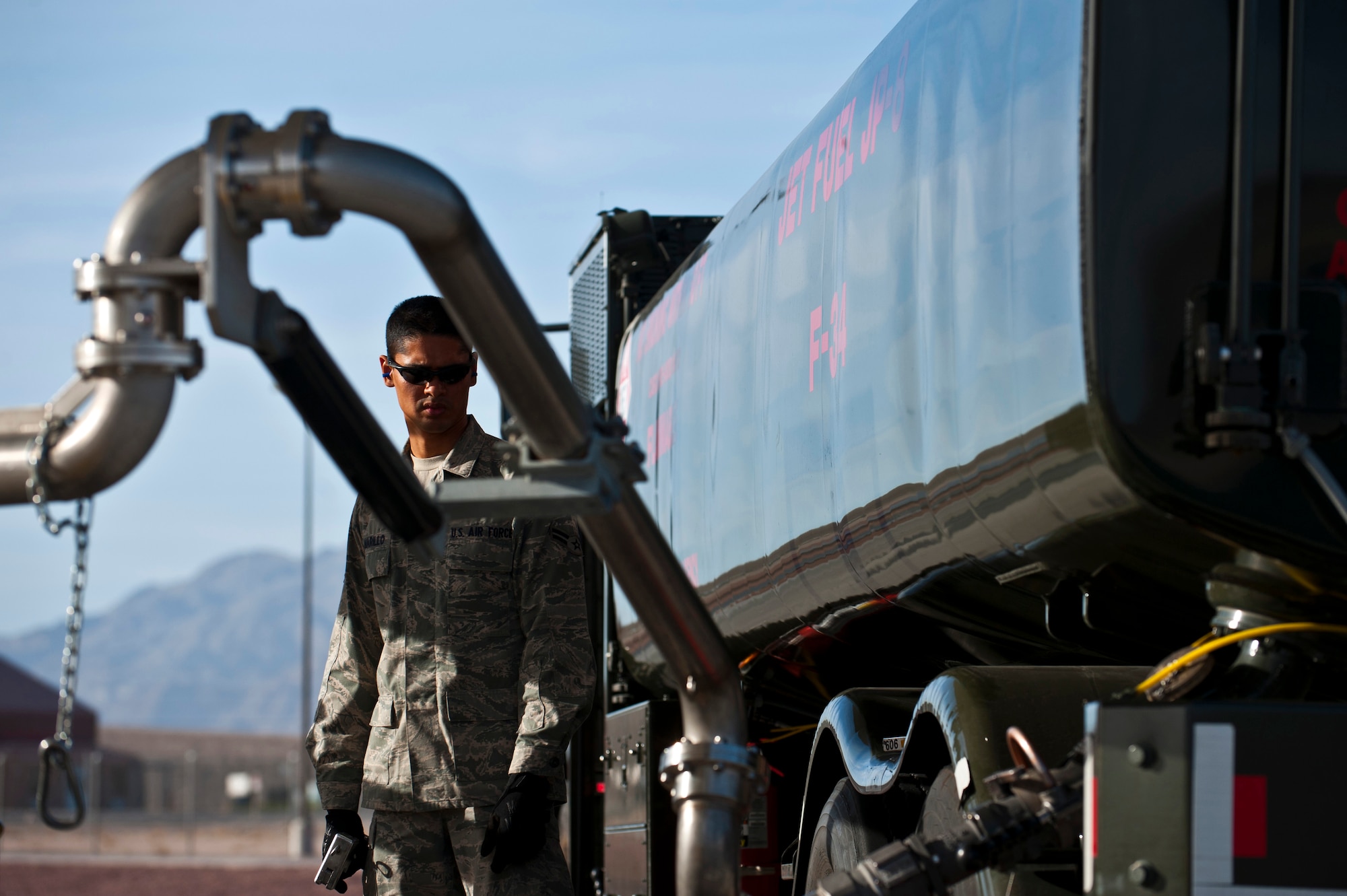 Airman 1st Class Michael Camarillo, fuels distribution apprentice, 99th Logistics Readiness Squadron, monitors fuel being pumped into an R-11 fuel truck Feb. 23rd, 2012 at Nellis Air Force Base, Nev. The Fuels Management Flight, responsible for fueling all aircraft at Nellis AFB, accomplishes its mission daily regardless of condition or number of airframes serviced. (U.S. Air Force photo by Senior Airman Brett Clashman)